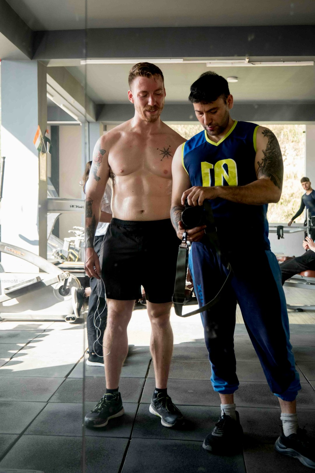 a-couple-of-men-standing-next-to-each-other-qyboul8tino